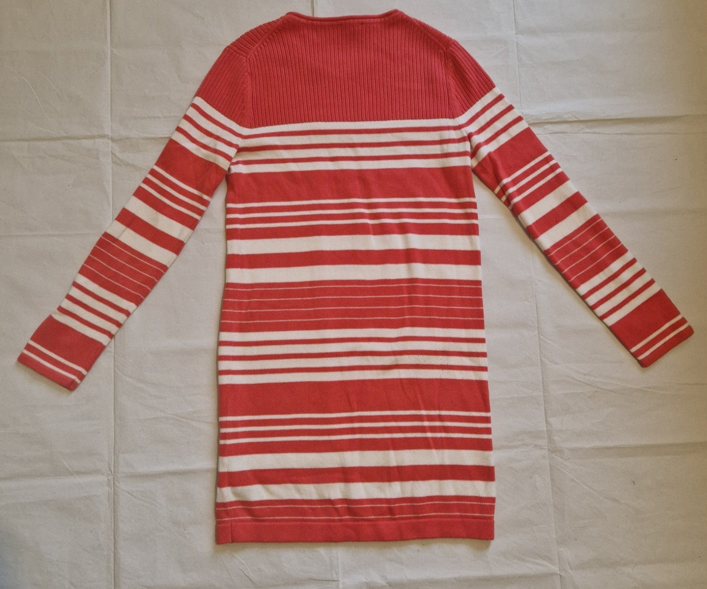 A red and white striped Tommy Hilfiger long-sleeved knitted jumper dress.