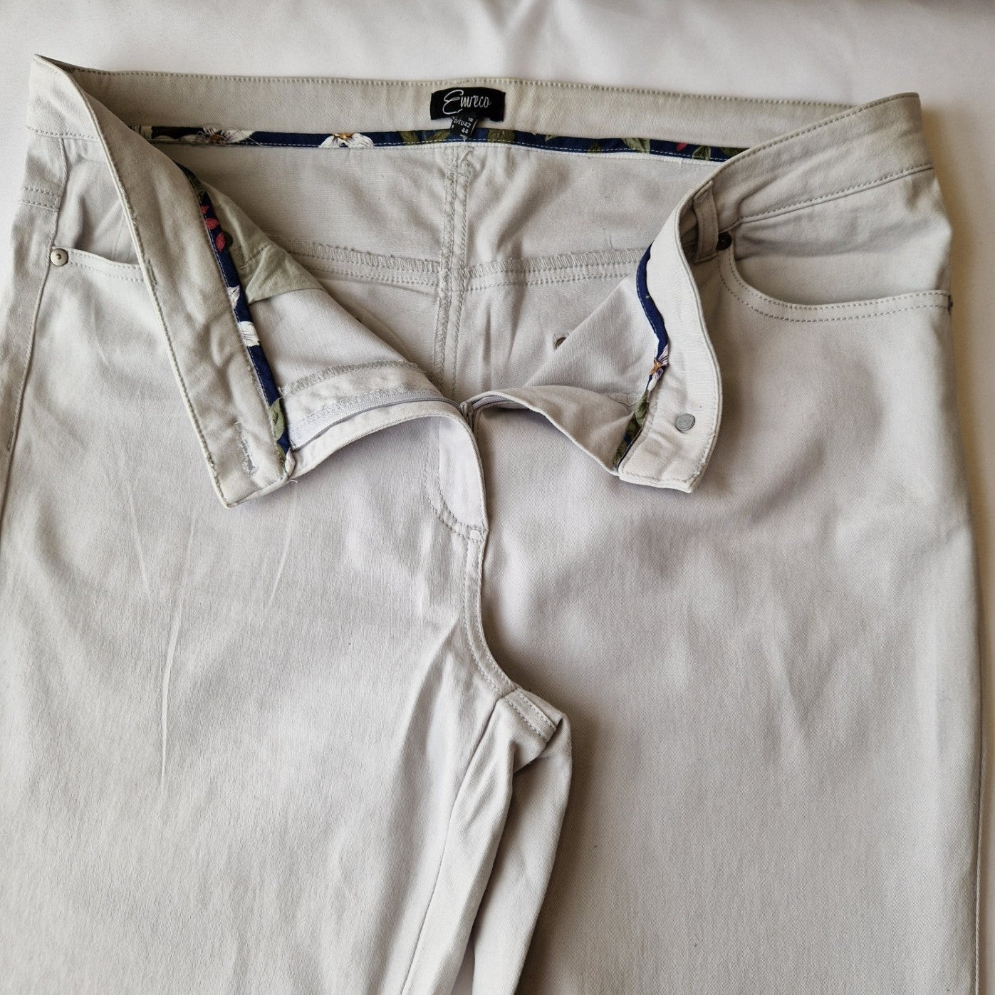 Beige Emreco straight leg corduroy chino trousers with a button and zip fly closure.