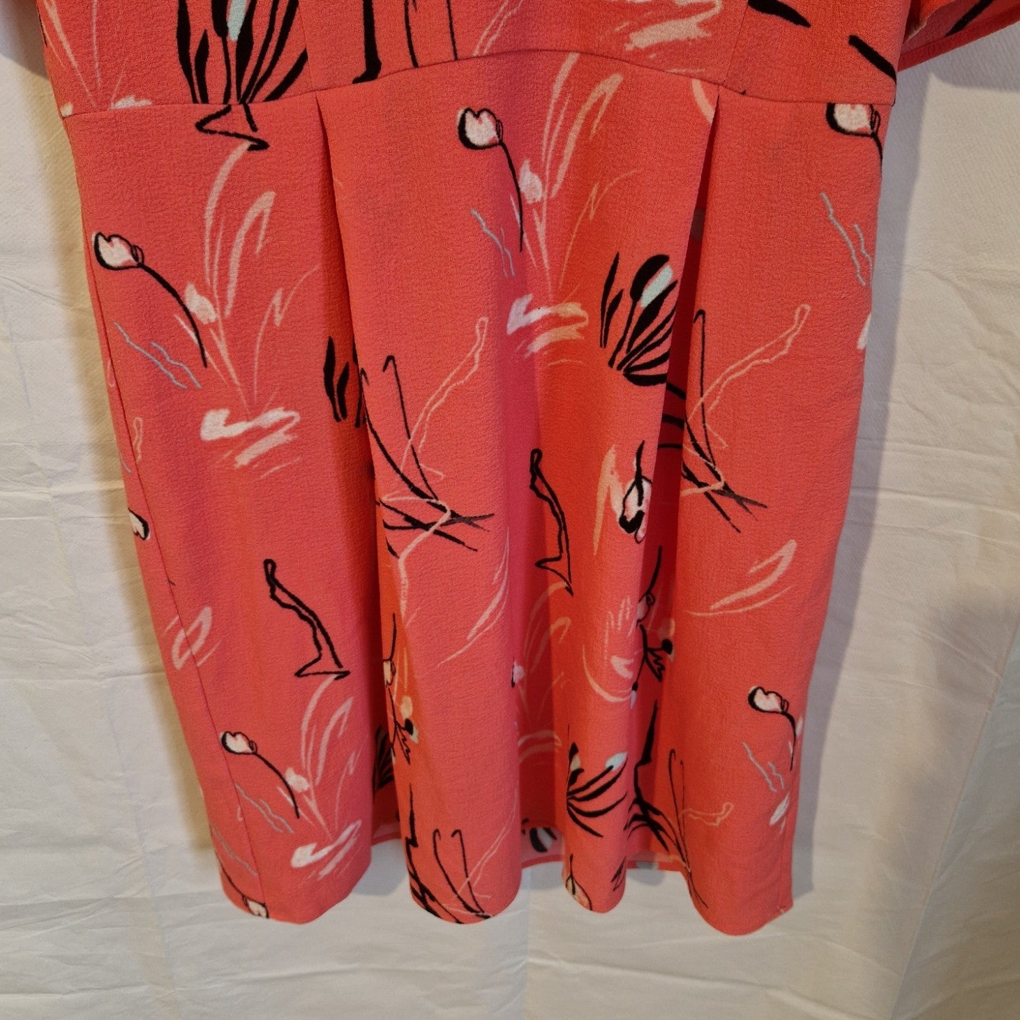 A pink Marks and Spencer fit and flare dress featuring a black and white floral print.