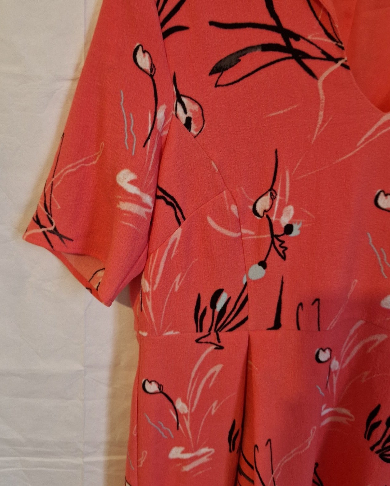 A pink Marks and Spencer fit and flare dress featuring a black and white floral print.