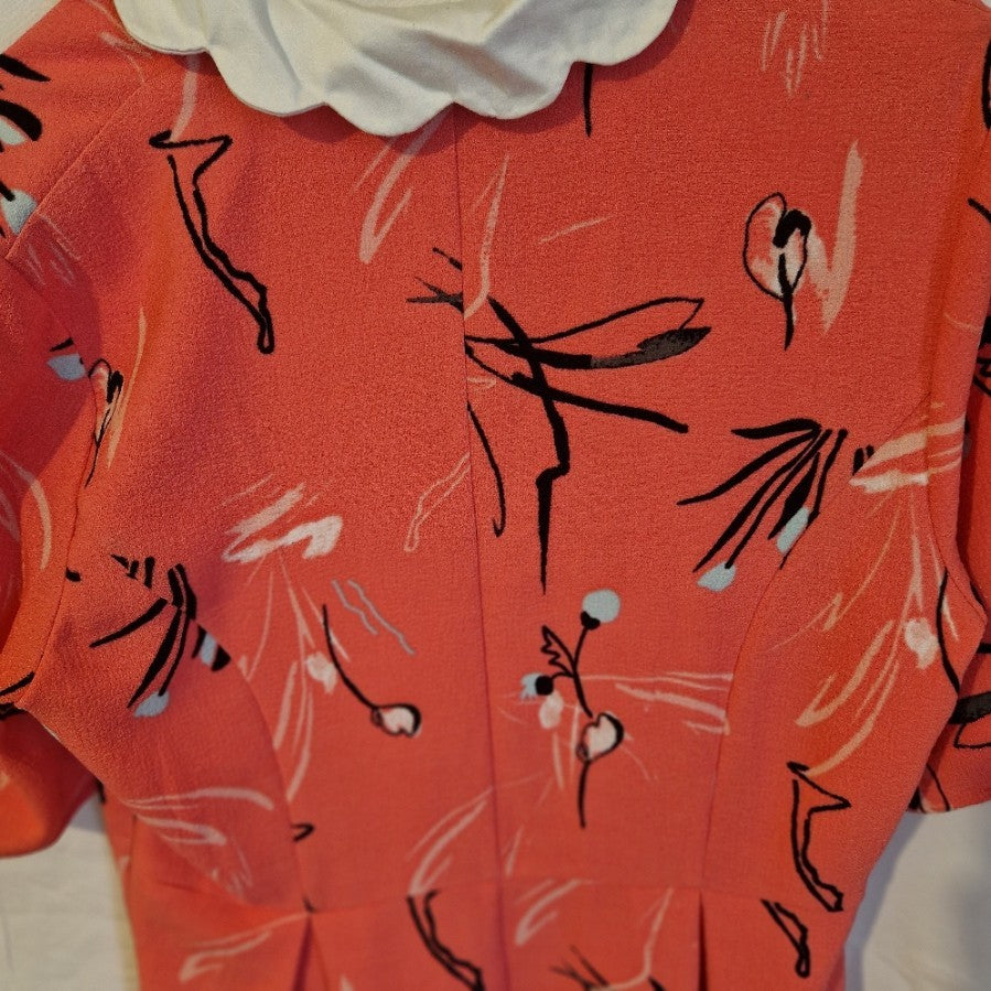 A pink floral fit and flare dress by Marks and Spencer with a white scalloped collar.