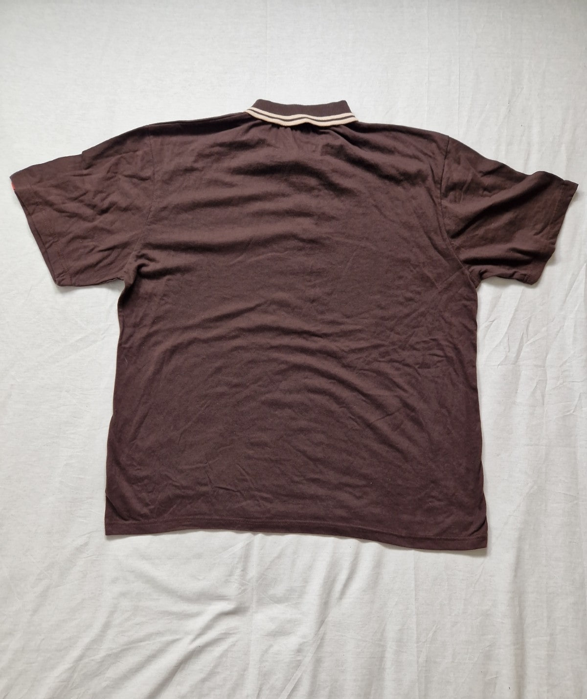 Brown polo shirt on a light gray background