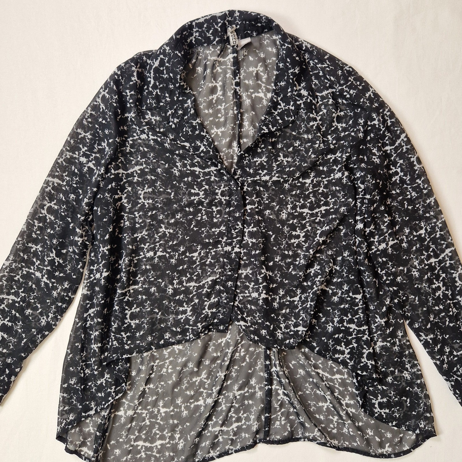 Black and white patterned jacket on a beige background
