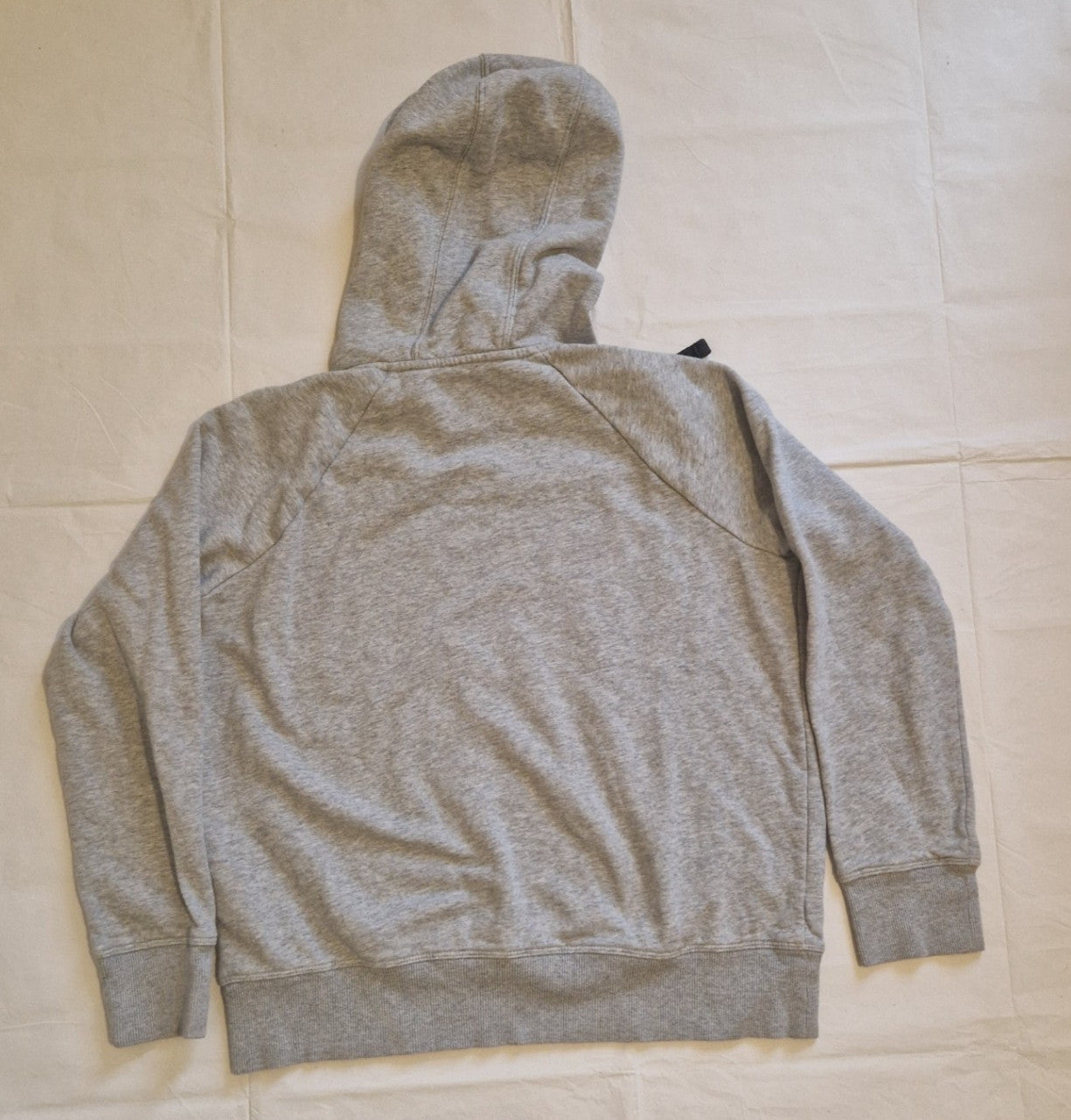 A grey Under Armour boys pullover fleece hoodie shown from the back.