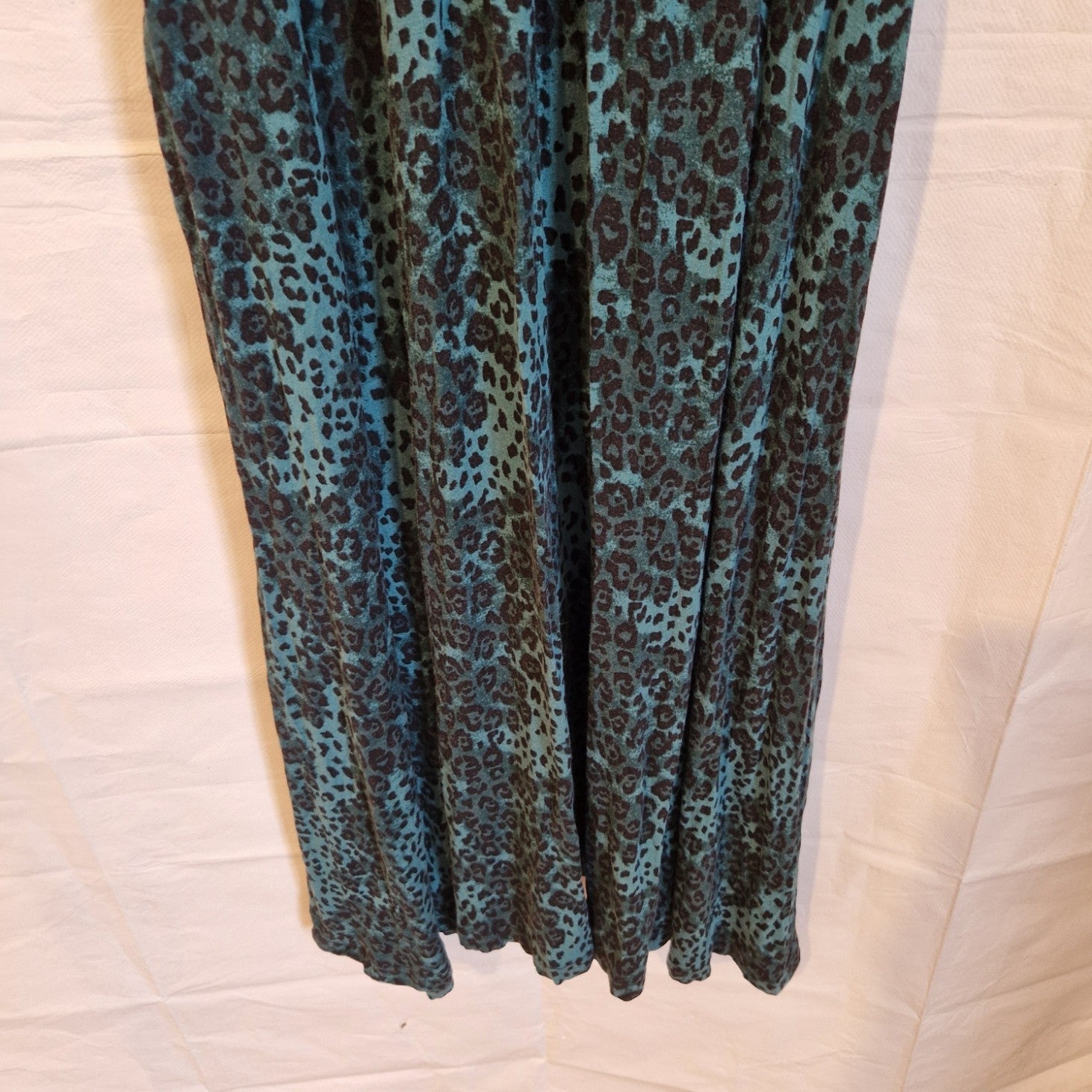 A teal and black leopard print maxi dress made from a flowing chiffon blend.