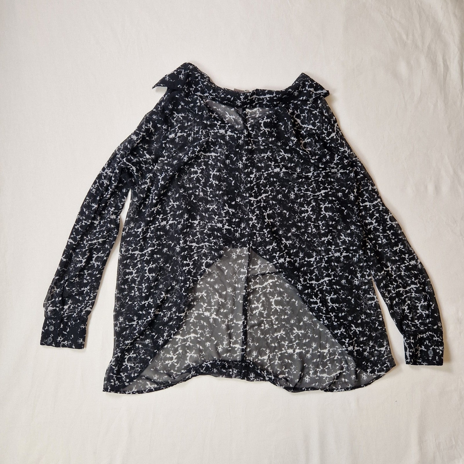 Black and white patterned blouse on a light background