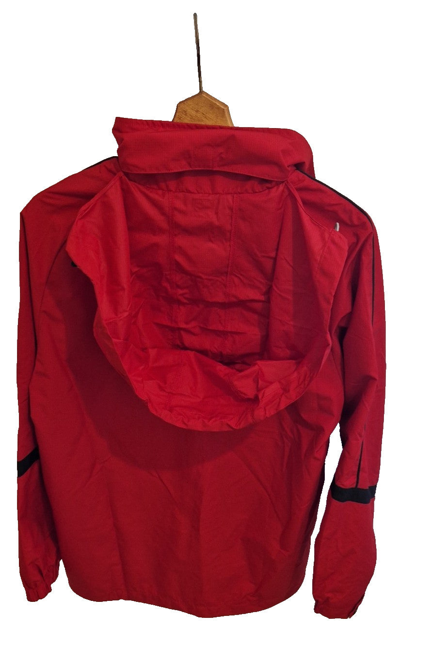 A red FBT Doncaster Rovers football training jacket with a hood hanging on a hanger.