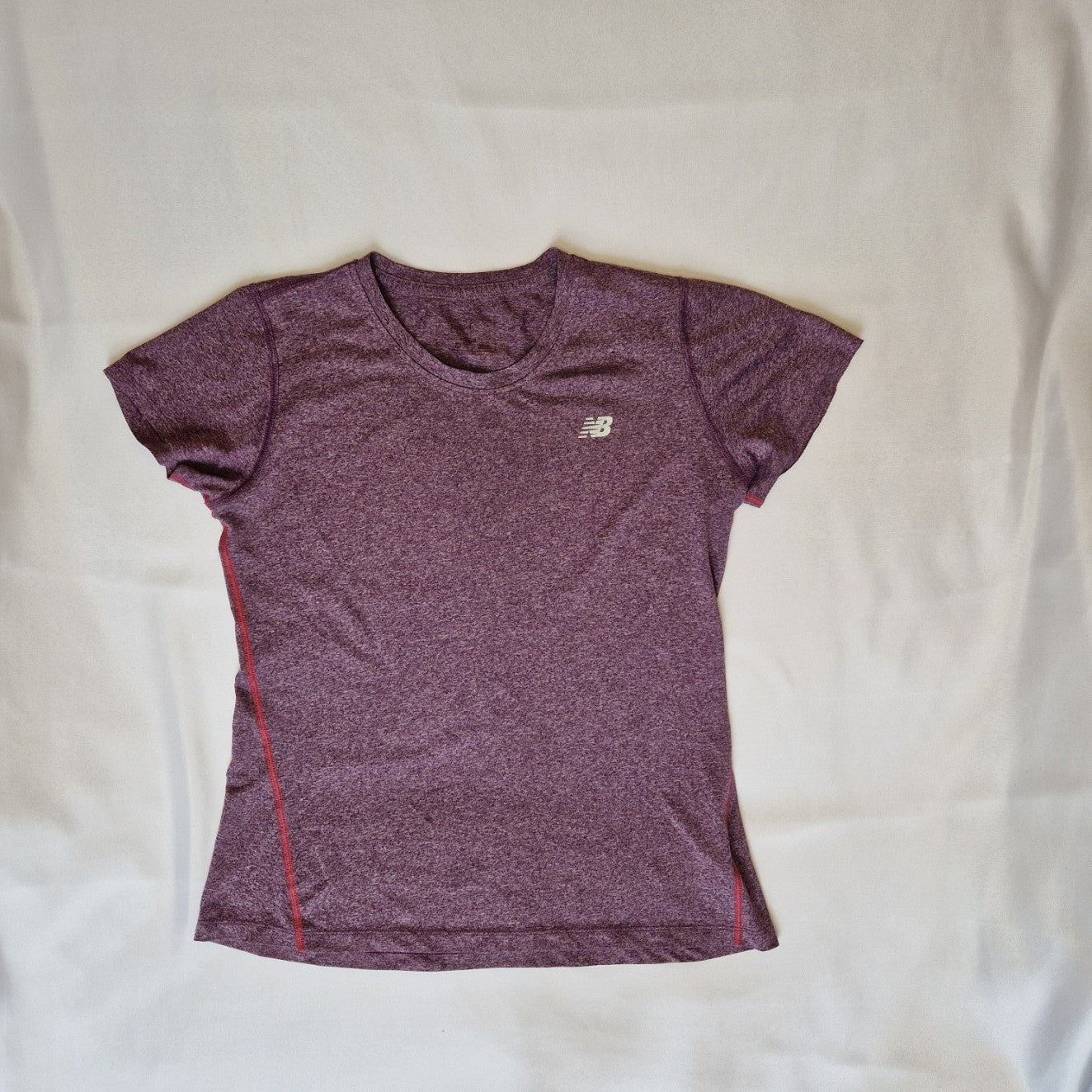 A purple New Balance women's short-sleeved running t-shirt with a round neck and athletic fit.