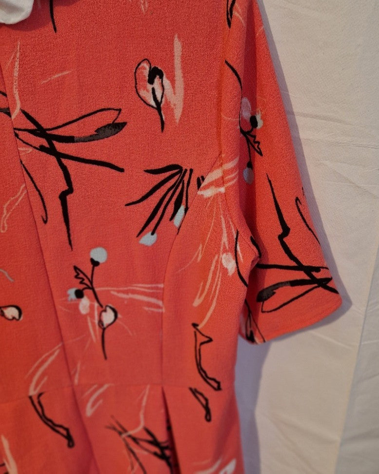 A pink Marks and Spencer fit and flare dress featuring a black and white floral print.