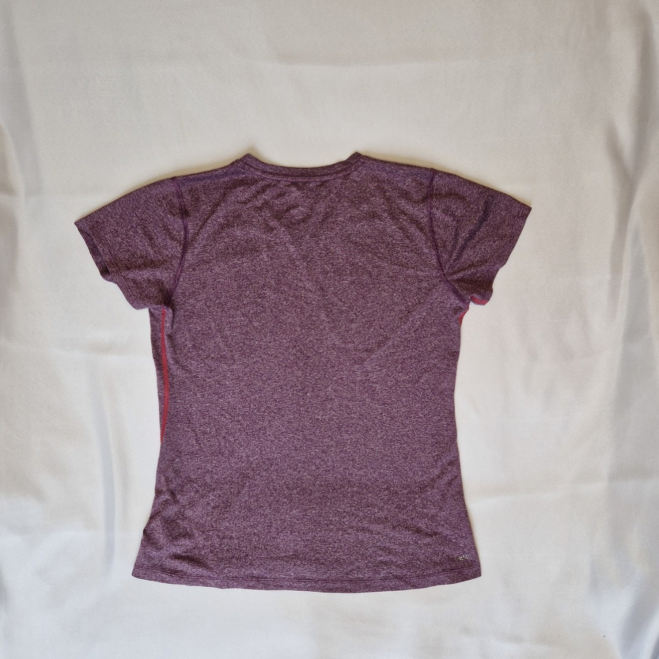 A purple New Balance women's short-sleeved running t-shirt with a round neck.