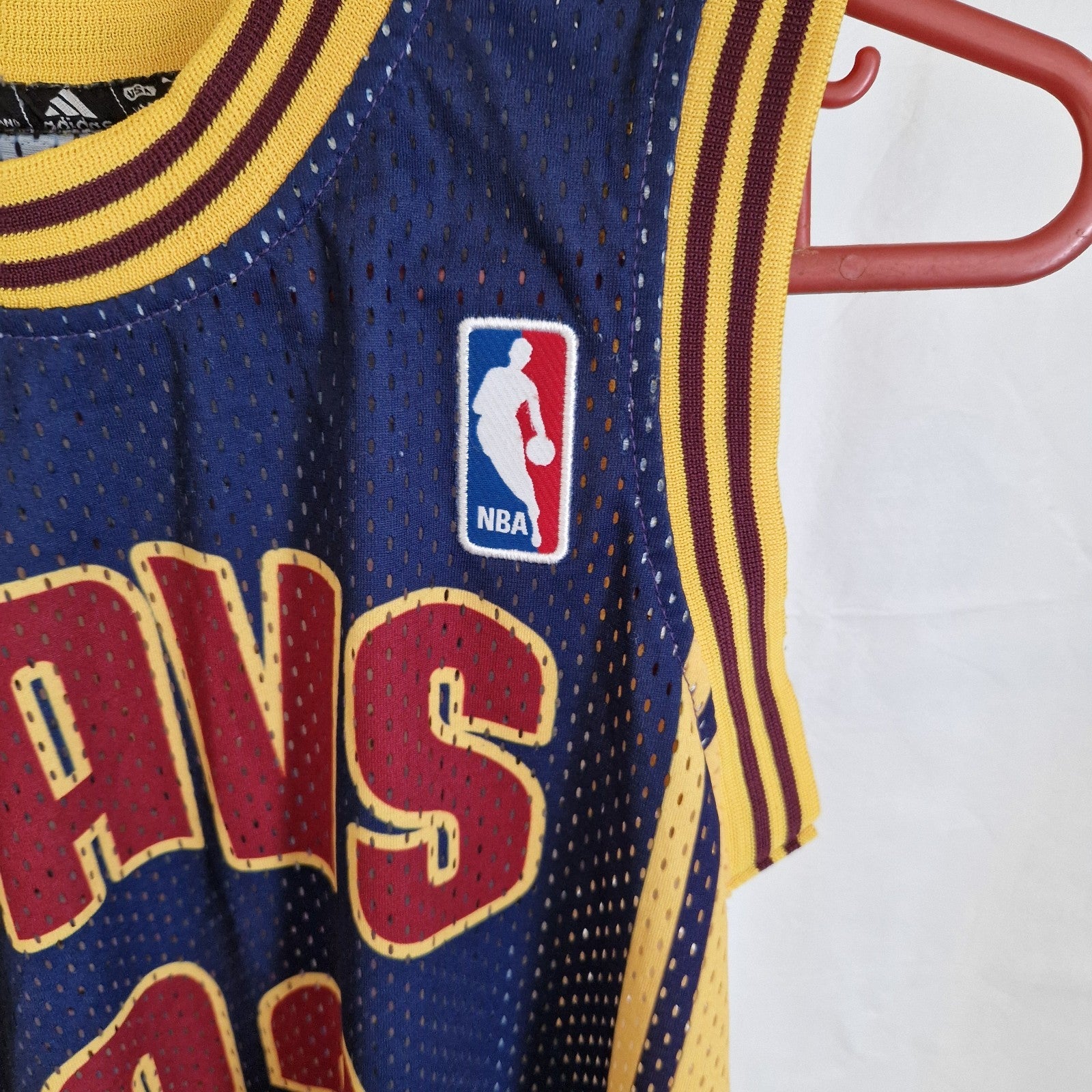 A blue Adidas Cleveland Cavaliers LeBron James jersey with yellow and maroon trim.