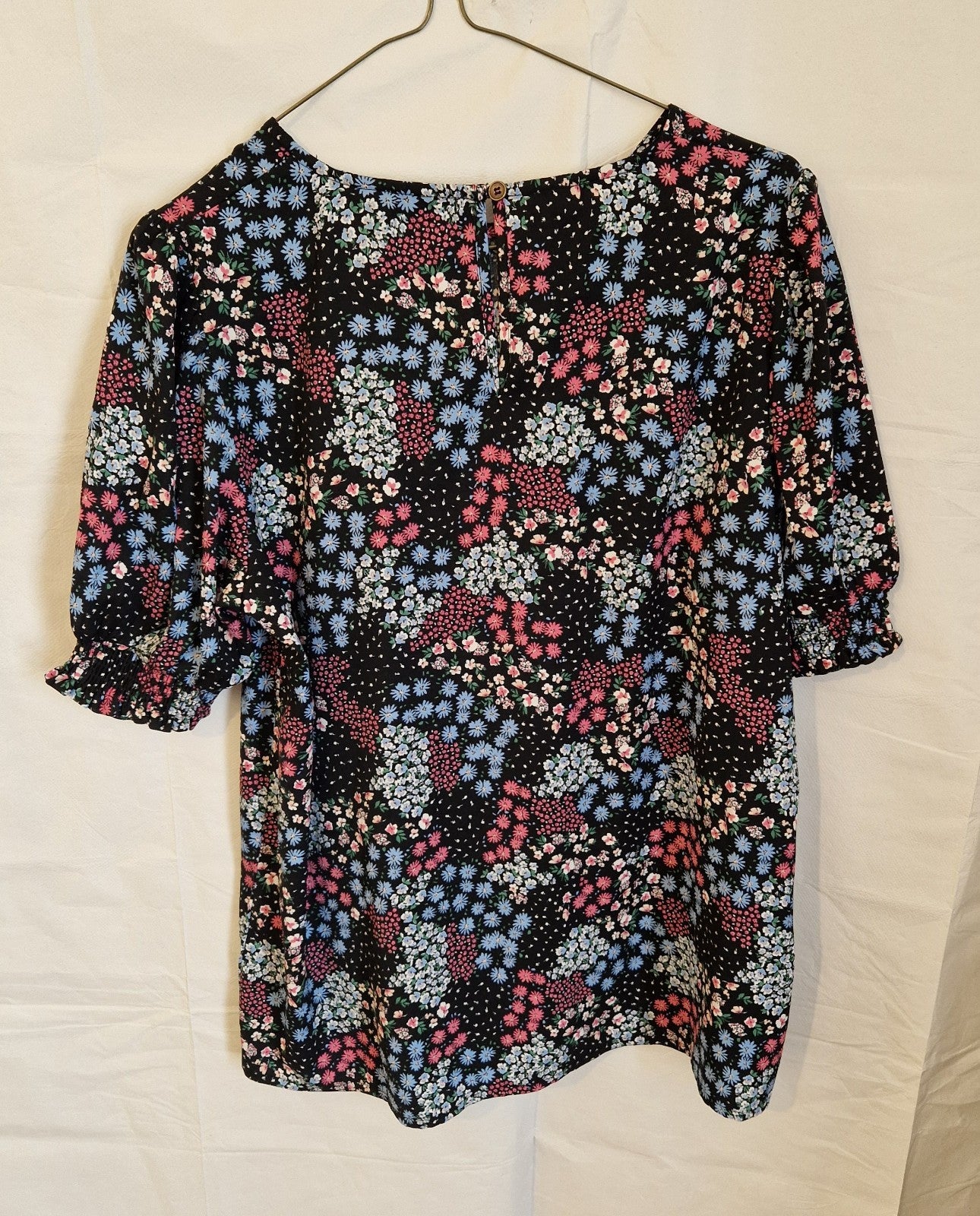 Cotton Traders women's black floral short sleeve blouse with a round neckline.