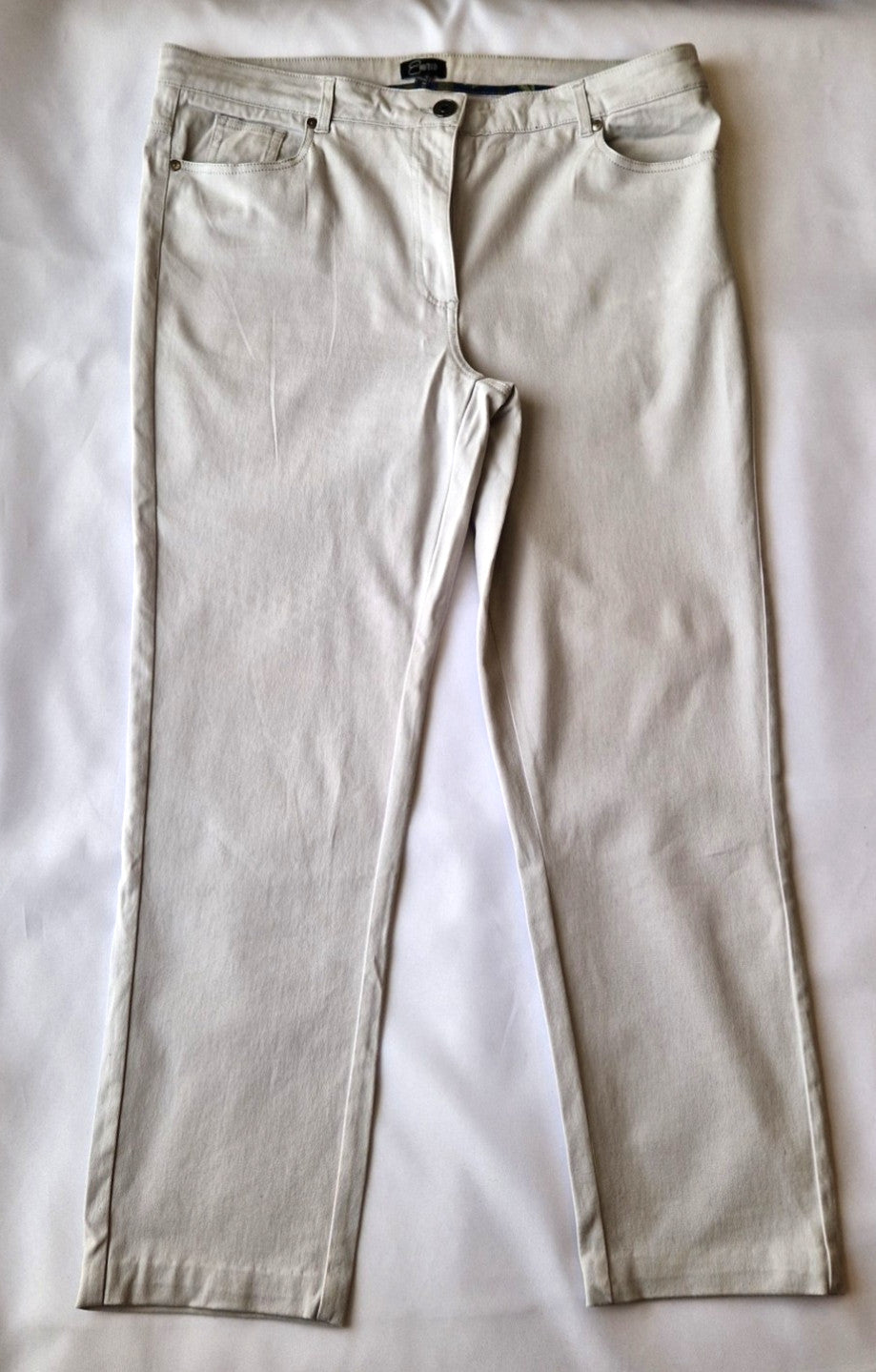 Emreco beige straight leg corduroy chino trousers with a zip and button closure.