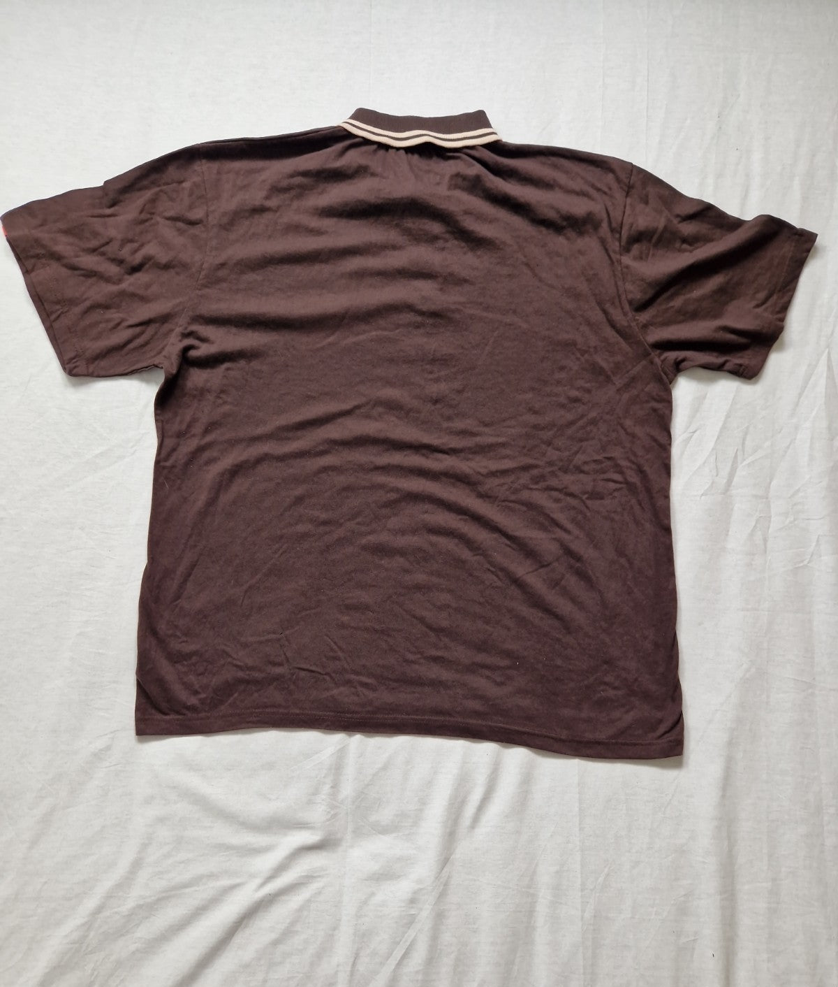 Brown polo shirt on a light gray background