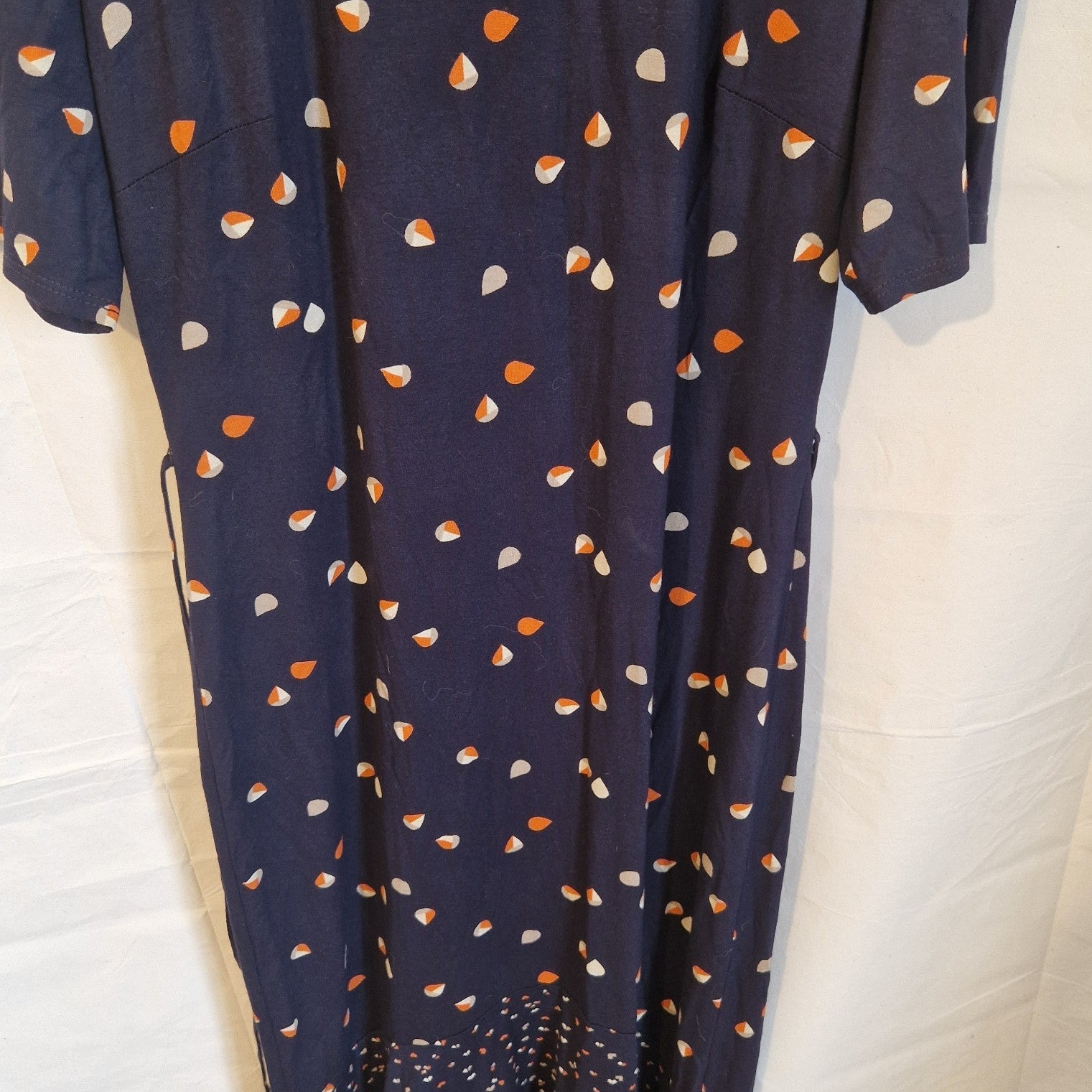 A navy blue Roman fit and flare dress featuring a multicoloured abstract print and short sleeves.