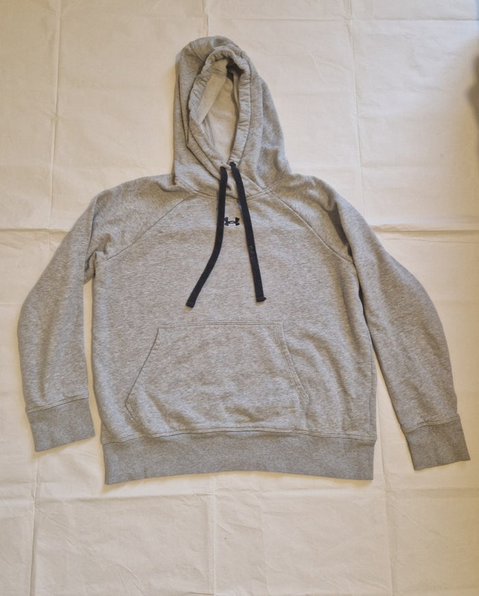 A grey Under Armour pullover hoodie with a front kangaroo pocket and black drawstring.