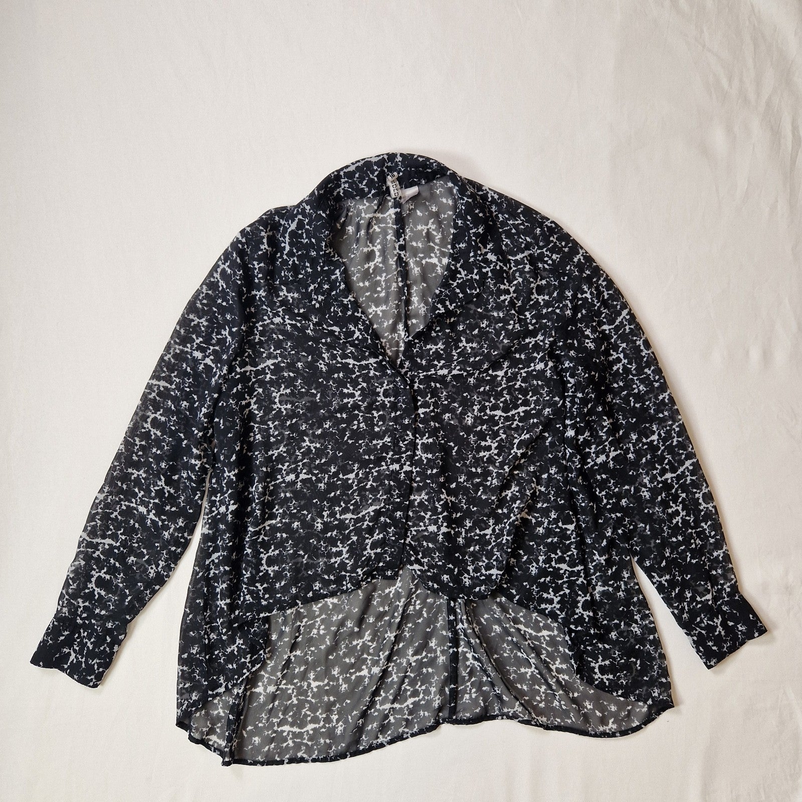 Black and white patterned shirt on a light beige background