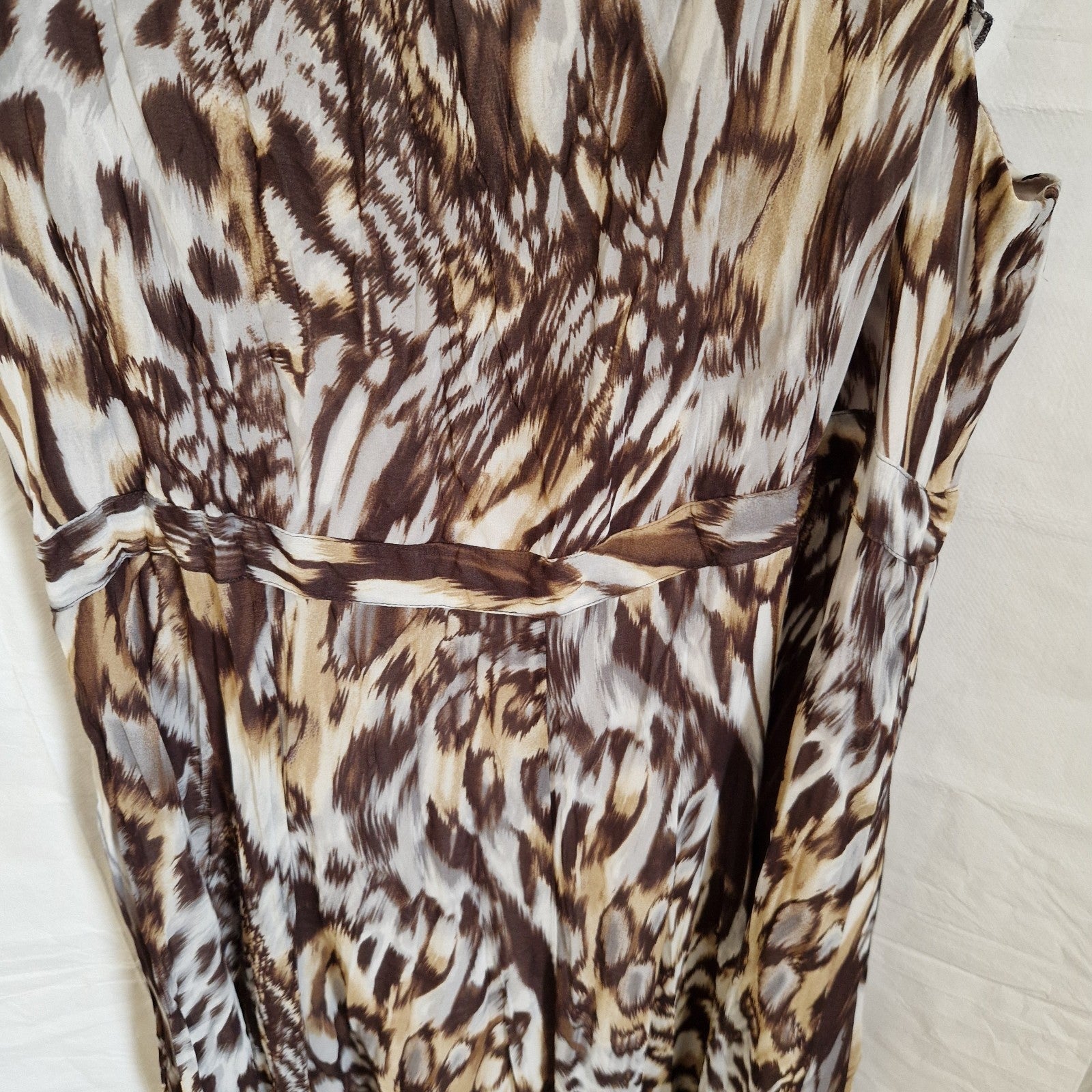 A brown and beige animal print chiffon maxi dress with a defined waistline.