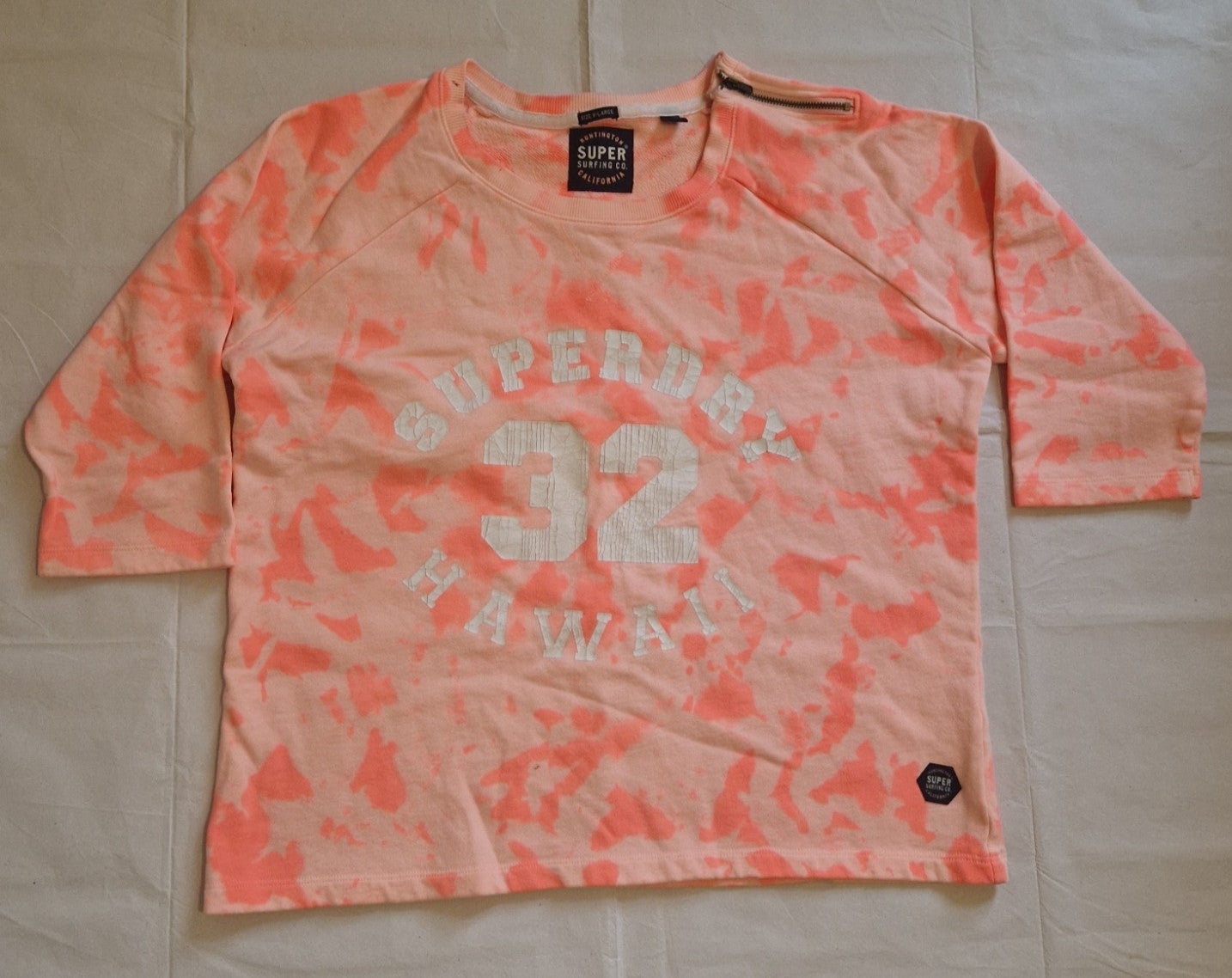 A pink and orange tie-dye Superdry cotton knit jumper with a quarter-zip and surf graphic.