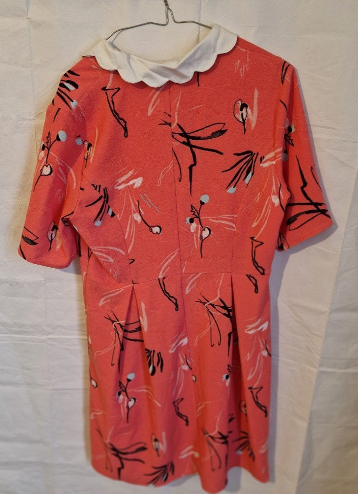 A pink floral fit and flare dress by Marks and Spencer with a white scalloped collar.