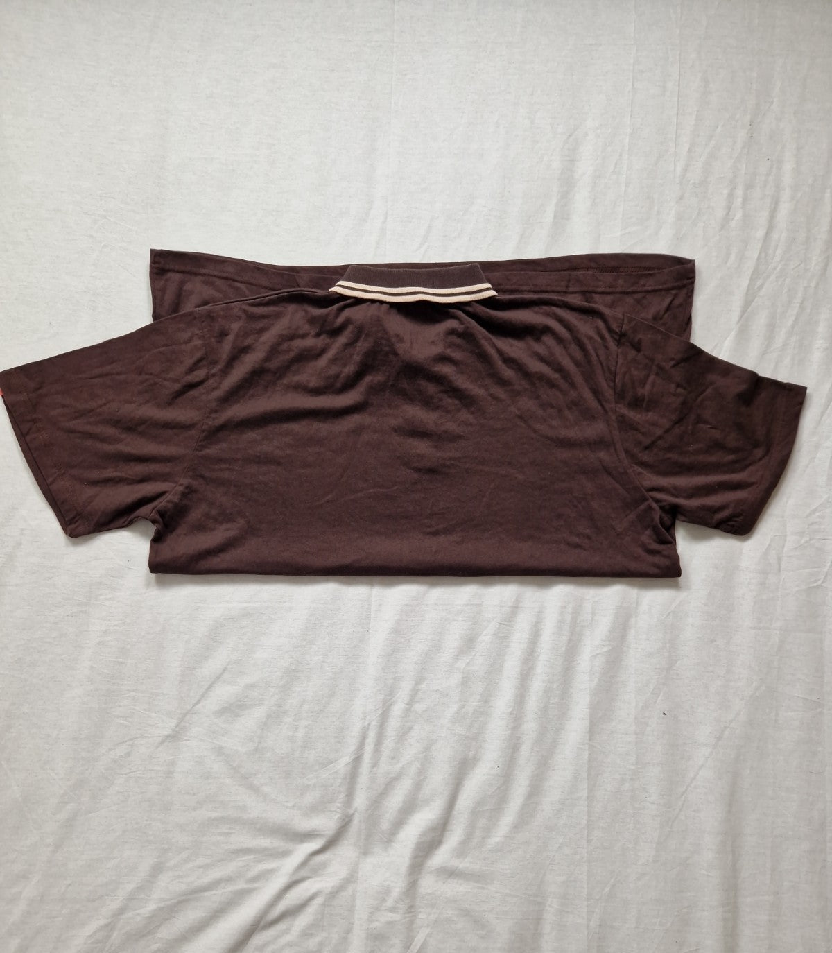 Brown t-shirt on a light gray surface