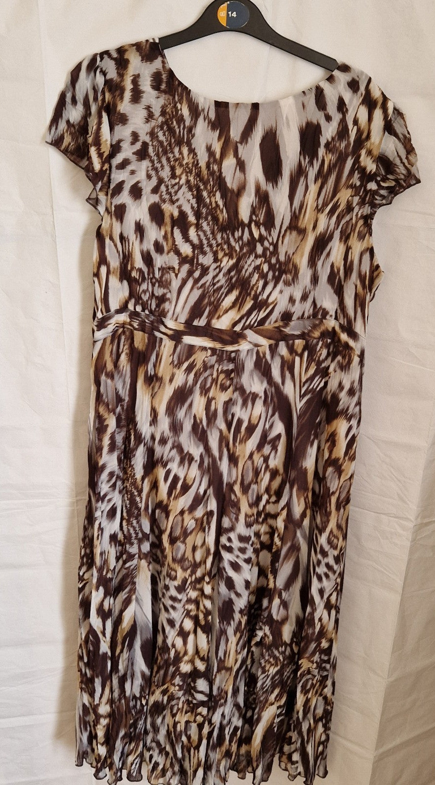 A brown and beige animal print chiffon maxi dress with short sleeves and a round neckline.