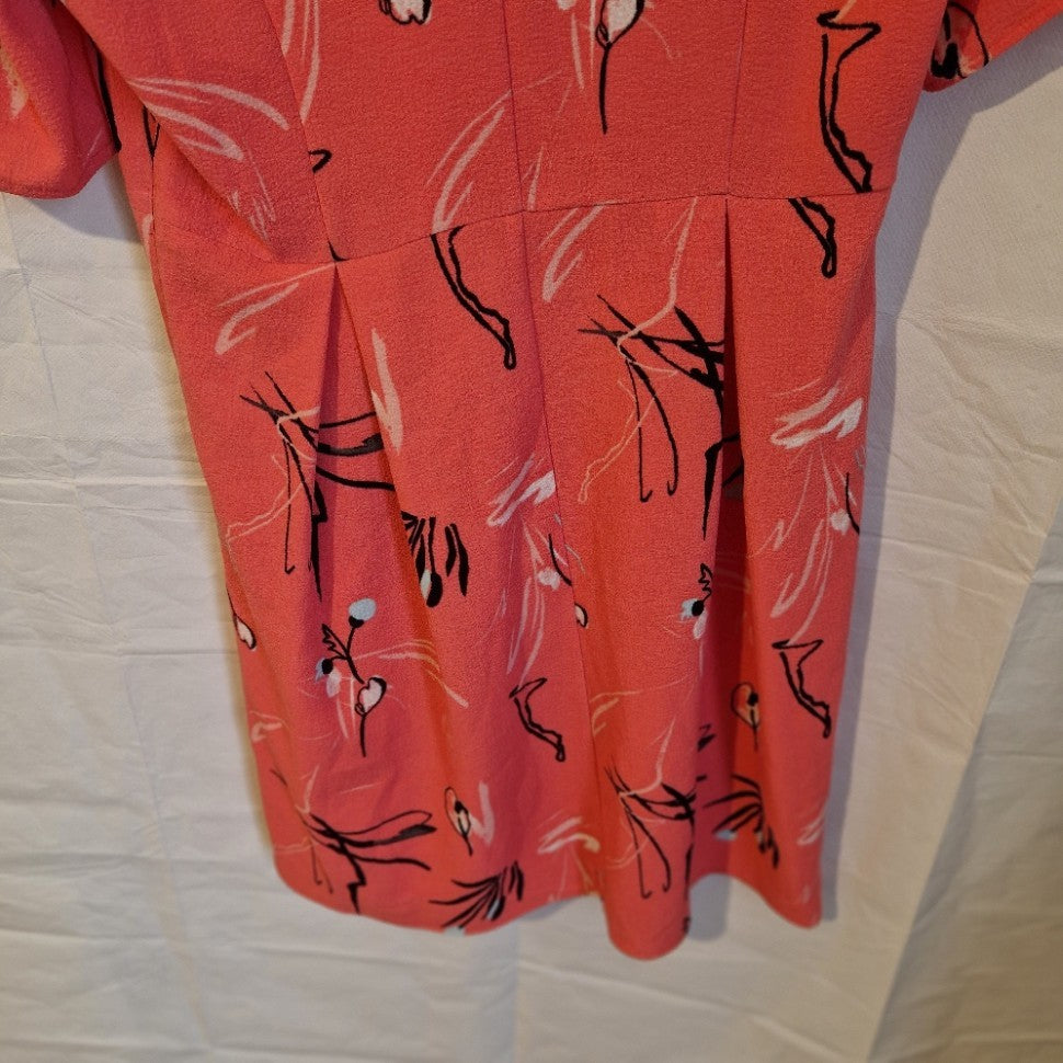A pink Marks and Spencer fit and flare dress featuring a black and white floral print.