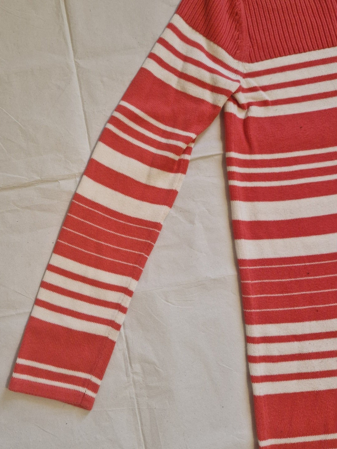 A red and white striped Tommy Hilfiger knitted jumper dress with long sleeves.
