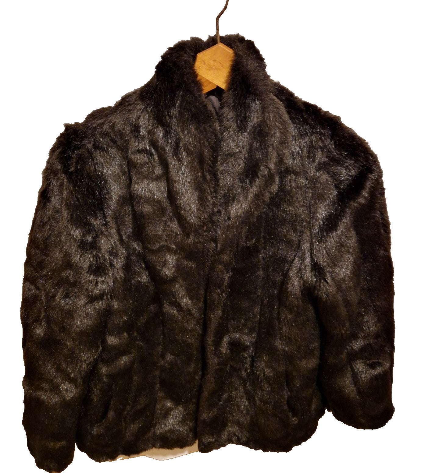 A dark brown Astraka vintage faux fur coat with a classic collar hanging on a wooden hanger.