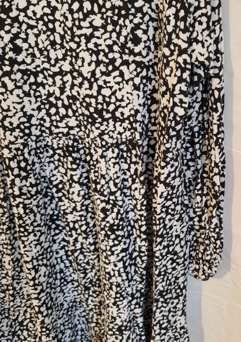 H&M midi dress in a black and white abstract floral print with long puff sleeves.